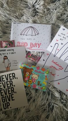 several greeting cards are laying on a furry surface with the words, you had a bad day and never ever give up