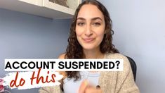 a woman holding up a sign that says, account suspended? do this in front of her