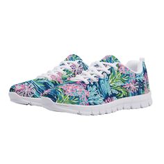 a women's sneakers with tropical print and white laces on the outs,