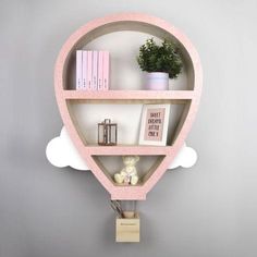 a hot air balloon shelf with books on it