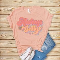 "\"Embrace coastal vibes with our Always Salty Unisex Jersey Tee! Featuring a cute retro graphic design, it's the perfect Beach Tee for anyone who loves the sea. Whether as a Gift for Her or a treat for yourself, this comfy, stylish shirt brings a touch of beachside charm to any wardrobe!\" .: Made with 100% Airlume combed and ring-spun cotton, a lightweight fabric (4.2 oz/yd² (142 g/m that is easy to layer, breathable. Perfect for active and leisure wear.  .: The retail fit that is perfect for casual and semi-formal settings. The crew neckline adds a classic, neat style that's perfect for accessorizing. .: Bella+Canvas manufactures all its products in the US and internationally in humane, no-sweat-shop, sustainable way and is part of the Fair Labor Association as well as Platinum WRAP cer Retro Graphic Design, Beach Tee, Coastal Vibes, Stylish Shirt, Neat Style, Jersey Tee, Stylish Shirts, Leisure Wear, Jersey Shorts