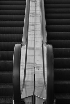 an escalator is shown in black and white, with the bottom half closed