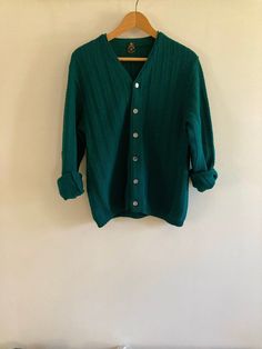 Fabulous vintage Ren-Dale knit cardigan in rich hunter green. The shade was hard to capture, just beautiful in person. Featuring a beautiful striped knit and finished with mother-of-pearl style buttons, this virgin wool cardigan is a perfect staple for spring and fall.  No flaws to note.  Marked a size Medium, I believe this is a men's sweater but would work for any gender.  Visit the Clothes | Shoes | Bags section for more handsome vintage menswear: https://www.etsy.com/ca/shop/LotusRoadVintage?section_id=27662622 Please visit my shop to see more gorgeous quality vintage items for your modern home: https://www.etsy.com/ca/shop/LotusRoadVintage?ref=seller-platform-mcnav Exciting news! Lotus Road Vintage has expanded and has launched a sister shop featuring only vintage print advertising. P Classic Green Wool Cardigan, Green Wool Knitted Cardigan, Vintage Green Knit Outerwear, Classic Green Textured Knit Sweater, Vintage Green Long Sleeve Cardigan, Retro Green Winter Sweater, Green Retro Winter Sweater, Green Vintage Cardigan, Green Textured Knit Cardigan For Winter