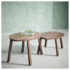 two wooden tables sitting next to each other