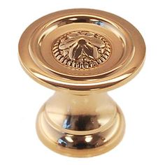 an antique brass cabinet knob with a lion emblem on it