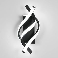 an abstract black and white sculpture on a gray background with the letter s in it's center