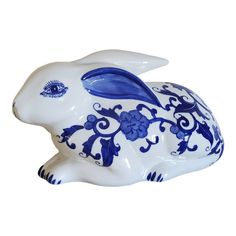 a blue and white ceramic rabbit figurine on a white background with an ornate design