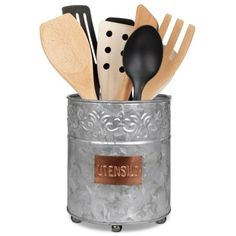 the utensil holder is filled with wooden spoons and spatulas