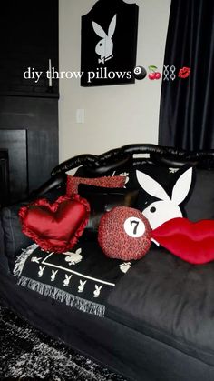 a bed with pillows on top of it in a room that has black and white decor