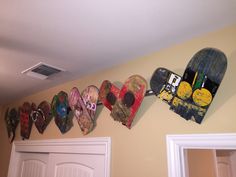 there are many skateboards hanging on the wall