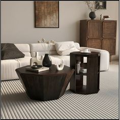 a living room with white couches and wooden tables in the center, on carpeted flooring