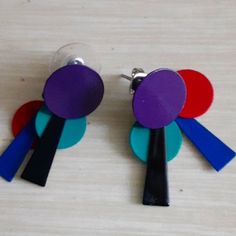 The Are A Purple, Red, Aqua, Black And Royal Blue Earring Set. They Are Directly Out Of The Early 80s. Never Worn. They Are 1.5 Inches Long. These Will Definitely Be Your "Go To" Earrings For Any And Every 80s Party That You Will Attend. These Also Just Add A Pop To Festival Clothing Or Really Anywhere You Want 1000 People To Say, "Oh My God, I Love Your Earrings." This Is My Final Price Before I Take Them Down And Just Keep Them Myself. They Are Just Too Cool. Retro Blue Earrings For Pierced Ears, Fun Purple Earrings For Party, Modern Purple Earrings For Party, Retro Blue Party Earrings, Retro Multicolor Earrings For Parties, Vintage Purple Earrings For Party, Royal Blue Earrings, Totally 80s, 80s Earrings