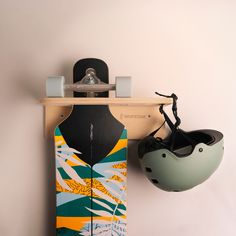 a skateboard and helmet hanging on a wall