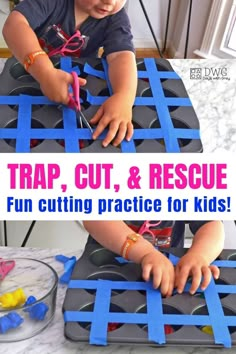 a young child cutting out pieces of construction paper with scissors and tape on the table