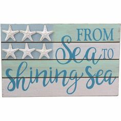 a wooden sign that says from sea to shining sea with stars on the top and bottom