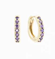 A classic huggie hoop with a purple cz stone studded accent. You will love these brightly adorned hoops to add some color to your outfit. Perfect for everyday wear because of their lightweight frame and comfortable fit.Size: 11mm, CZ Stones Elegant Small Hoop Purple Earrings, Elegant Purple Small Hoop Earrings, Elegant Purple Pierced Hoop Earrings, Elegant Gold Amethyst Hoop Earrings, Purple Gemstone Hoop Earrings, Simple Gold Earrings, Zodiac Bracelet, Stone Studs, Zodiac Necklaces