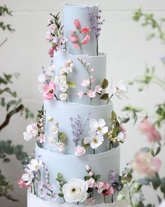 a three tiered cake with flowers on it