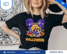 a woman wearing a mickey mouse halloween shirt