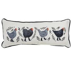 three chickens embroidered on a white pillow with black trimmings and an orange beak