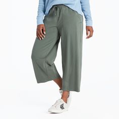 Get comfy in our take on wide-leg cropped pants, made from our signature, stretchy Crusher-FLEX jersey fabric. These relaxed bottoms are perfect for everything from lounging to running errands. 92% USA Grown Cotton, 8% Spandex 7.08oz Mid-weight cotton/spandex jersey, garment washed for softness. Elastic encased self waistband with drawcord. Slash pockets with self binding. Life Is Good® twill patch. 24" Inseam. Imported | Life is Good Women's Solid Crusher-FLEX Crop Pants T-Shirt in Dark Moss Gr Casual Wide-leg Joggers With Elastic Side Panels, Loungewear Capris With Pockets, Cropped Leg, Casual Capri-length Yoga Pants With Pockets, Comfortable Full-length Joggers With Pockets, Relaxed Fit Full-length Joggers With Side Pockets, Positive Lifestyle, Wide Leg Cropped Pants, Children In Need, Moss Green