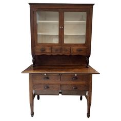 an old wooden cabinet with glass doors and drawers