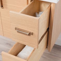 an open drawer with towels in it