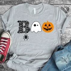 a t - shirt with two pumpkins and a ghost on it