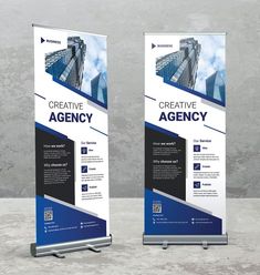 two roll up banners with the words creative agency in blue and black on them against a concrete background