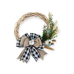 a wreath with a black and white bow