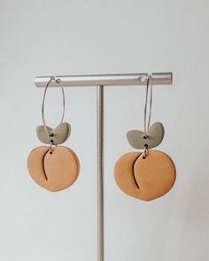 Handmade polymer clay peach earrings with your choice of gold or silver metal Ear wire closure Hypoallergenic metal - free of nickel & lead Clay earrings are lightweight & comfortable enough for all-day wear Due to handmade nature, slight imperfections and differences may occur in each pair of earrings Earthy Everyday Earrings With Ear Wire, Orange Minimalist Earrings For Everyday, Minimalist Orange Earrings For Everyday, Everyday Minimalist Orange Earrings, Everyday Hypoallergenic Orange Earrings, Small Hoop Polymer Clay Earrings For Everyday, Trendy Dangle Clay Jewelry, Trendy Clay Dangle Jewelry, Handmade Minimalist Orange Earrings