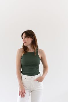 "Best ribbed green tank. Super soft cotton. Flattering Shape. This is our standard Verona overdyed to a Eucalyptus Green. We love this color! Also super cute when cropped. **Stitching is either Eucalyptus or a brighter green as shown. Let us know your preference in order notes. Maker: Military  |  Material: 100% cotton stretches Condition: Excellent. Washed Deadstock. OR IMPERFECT - Small Marker-tip size spots/ sun spots  X-SMALL Chest: 10-11\" unstretched |  Length: 25\" SMALL: Chest: 12-13\" u Basic Green Seamless Tops, Fitted Olive Sleeveless Top, Basic Green Tank Top, Fitted Sleeveless Olive Top, Fitted Green Everyday Tops, Everyday Fitted Green Tops, Fitted Green Tank Top For Everyday, Green Fitted Top For Everyday, Olive Fitted Casual Top