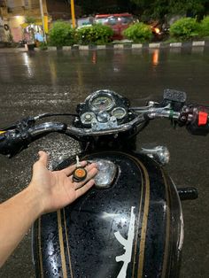 a hand is on the handlebars of a motorcycle