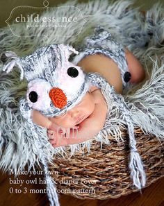 a baby is laying in a basket with a stuffed animal on it's head