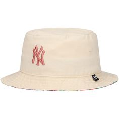 the new york yankees bucket hat is white and has a red ny logo on it