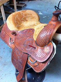 an old saddle is being worked on in a shop