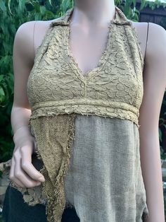 Introducing the Earthy Pixie Halter, our Lace and Rag Cotton Asymmetrical Boho Hippie Tribal Open Tie-Back Summer Halter Top. This unique piece is crafted with intricate lace detailing and soft, breathable rag cotton, perfect for those warm summer days. The asymmetrical design adds a touch of avant-garde style, while the boho hippie tribal influences bring a free-spirited charm to your wardrobe. Featuring an open tie-back for an adjustable fit, this halter top is both comfortable and stylish, ma Cheap Bohemian Halter Top, Summer Lace Top With Patchwork, Summer Lace Patchwork Tops, Bohemian Cotton Lace Patchwork Top, Lace Patchwork Tops, Summer Halter Tops, Pixie Fairy, Pixies Fairies, Avant Garde Fashion