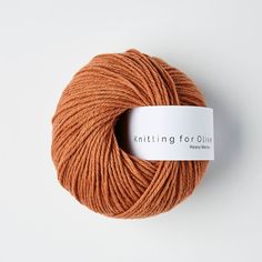 a skein of orange yarn with a white tag on the end that says knitting for quilts