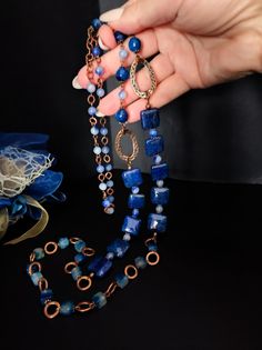 This is a very long ethnic style necklace made with large square dragon venis agate stones dyed blue. The necklace is asymmetrical with copper-plated brass decorative elements. To finish the necklace I used agate stones in different shapes. The necklace in the classic chain necklace style, very suitable for a single color dress or winter sweater. For those who love elegant retro style. All jewels are delivered in a decorated box, ready to be given as a gift to your loved one. How to take care of your jewellery: put on your beauty products (cosmetics, perfumes, ...) before wearing your precious jewel. Clean your jewelry with a soft cloth after wearing. Don't use water. Make sure you store your jewelry separately to avoid scratching it. Store away from heat sources, in a dry place in the spe Bohemian Blue Rectangular Necklace, Handmade Jewelry With Blue Rectangular Stone, Handmade Blue Jewelry With Rectangular Stone, Handmade Blue Rectangular Necklace, Blue Gemstone Beads Long Necklace Gift, Bohemian Blue Necklace With Rectangular Pendant, Handmade Blue Long Necklace For Gift, Bohemian Blue Rectangular Pendant Necklace, Artisan Blue Rectangular Necklace