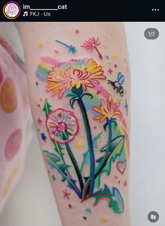 a colorful flower tattoo on the arm