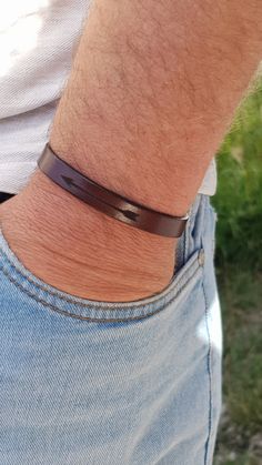 "Leather bracelet with engraved arrow.   Made from genuine leather.   Color of the bracelet - dark brown, light brown or black.   Bracelet width - 0.4\" or 10 mm.   Size of the engraved arrow - 1.5\" ( 38 mm).   Bracelet has a magnetic stainless steel clasp.   Color of the clasp - silver or gold.  You can choose a bracelet with only engraved arrow on the outside.   Or with an engraved arrow on the outside and with text on the inside of the bracelet.   Handmade. Handmade jewelry, engraved bracelets, personalized bracelets, engraved jewelry, personalized jewelry, vegan bracelets, vegan jewelry, cork bracelets, cork jewelry, genuine leather bracelets, genuine leather jewelry, cross bracelets, sets for two, bracelets for kids, jewelry for kids, personalized bracelets for kids,  engraved bracel Adjustable Brown Wristband For Father's Day, Minimalist Brown Bracelet With Leather Strap, Minimalist Brown Bracelets With Leather Strap, Minimalist Brown Leather Strap Bracelet, Modern Brown Cuff Bracelet As A Gift, Modern Brown Cuff Bracelet As Gift, Casual Brown Cuff Bracelet As A Gift, Casual Brown Cuff Bracelet As Gift, Modern Brown Wristband As A Gift