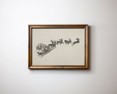 a framed drawing of santa's sleigh and reindeers