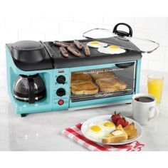 a red toaster oven sitting on top of a counter next to eggs and sausages