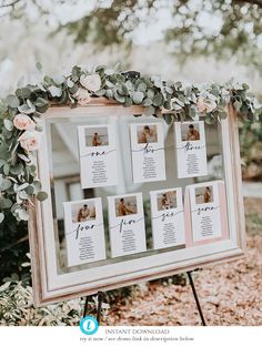 a wedding seating chart with flowers and greenery is displayed in front of a mirror