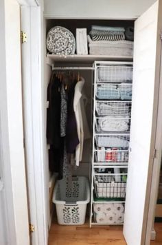 an organized closet with clothes, baskets and other items in it's doors open