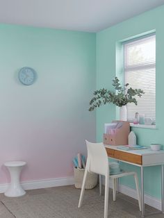 there is a desk and chair in the room with pastel paint on the walls