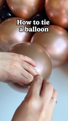 two hands reaching for some shiny balls with the words how to tie a balloon on it