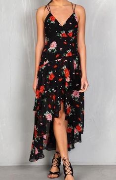 Our Floral Tiered Ruffle High-Lo Maxi Dress is a bestseller! Perfectly draped and flowy, this dress is great for weddings, date nights, parties, or vacation. This dress is sure to stun and get lots of compliments with its criss-cross adjustable straps, high-low hem with subtle ruffles, and beautiful red and black floral print! This dress is a bestseller! Don't wait for it to sell out! Hi-low hem with slight ruffle Criss-cross adjustable straps Back zip closure with hook & eye Lined 100% Poly Flirty Ruffle Hem Maxi Dress For Garden Party, Flirty Maxi Dress With Ruffle Hem For Garden Party, Summer Chiffon Maxi Dress With Ruffled Skirt, Flirty Tiered Maxi Dress For Summer, Summer Vacation Midi Dress With Ruffled Skirt, Summer Midi Dress With Ruffled Skirt For Vacation, Flirty Asymmetrical Hem Midi Dress For Summer, Flirty Tiered Maxi Dress For Garden Party, Flirty Flowy Maxi Dress With Ruffles