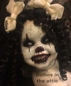 a creepy doll with black hair and white make - up on it's face