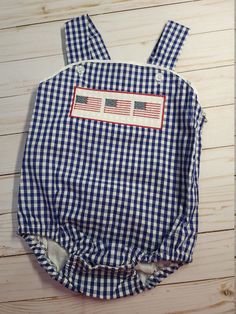 Boy smocked sunsuit * navy gingham sunsuit * 100% cotton * fully lined * snaps at the crotch * button at the shoulders * faux smocked flag design * ships within 5-7 business days Thanks for shopping with Sew Blessed Stitches!! We would love to connect with you on social media! You can find us at: Instagram@sewblessedstitches Facebook.com/sewblessedstitches Email - sewblessedstitches Smocked Baby Clothes, Boys Smock, Bubble Boy, Easter Applique, Personalized Easter Bunny, Navy Gingham, Personalized Backpack, Applique Shirts, Baby Diaper Bags