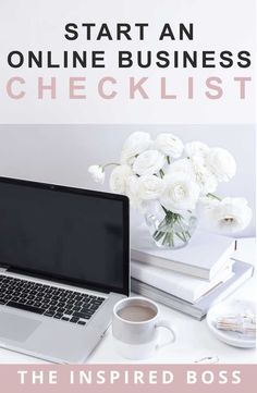 a laptop computer sitting on top of a white desk next to a cup of coffee